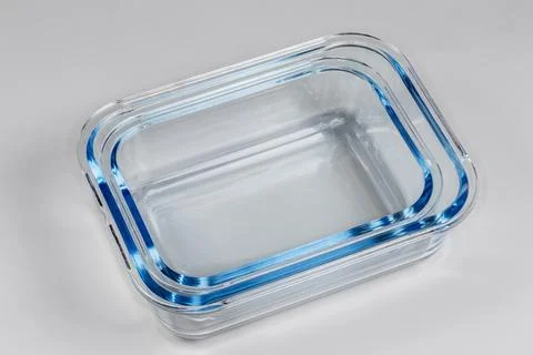 Stacked empty food containers of tempered glass on gray background Stock Photos