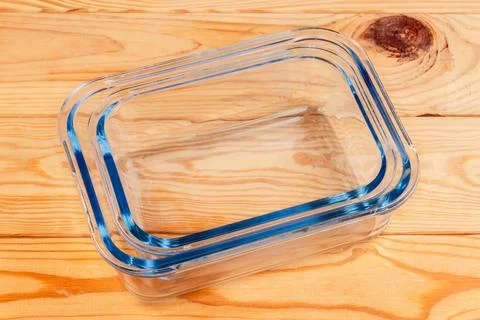 Stacked empty food containers of tempered glass on rustic table Stock Photos