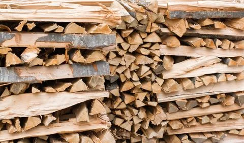 Stacked firewood in several rows Stock Photos