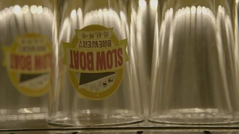 Stacked Glasses on Bar Counter in Beijing Brewery Interior, Ready for Service Stock Footage 345760939