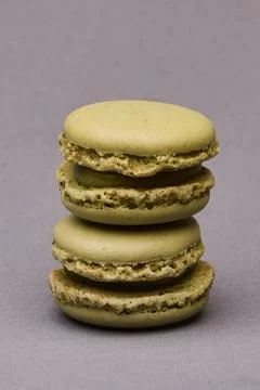 Stacked green macarons on gray background Stock Photos