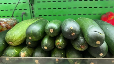 Stacked Green Zucchini Squash on Supermarket Shelf Stock Footage 337911066