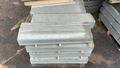 Stacked grey concrete coping stones on wooden pallets outdoors Vidéo 339723007