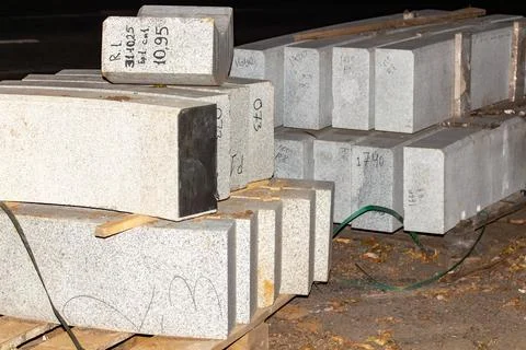 Stacked grey granite slabs for construction and architectural design on wood Stock Photos