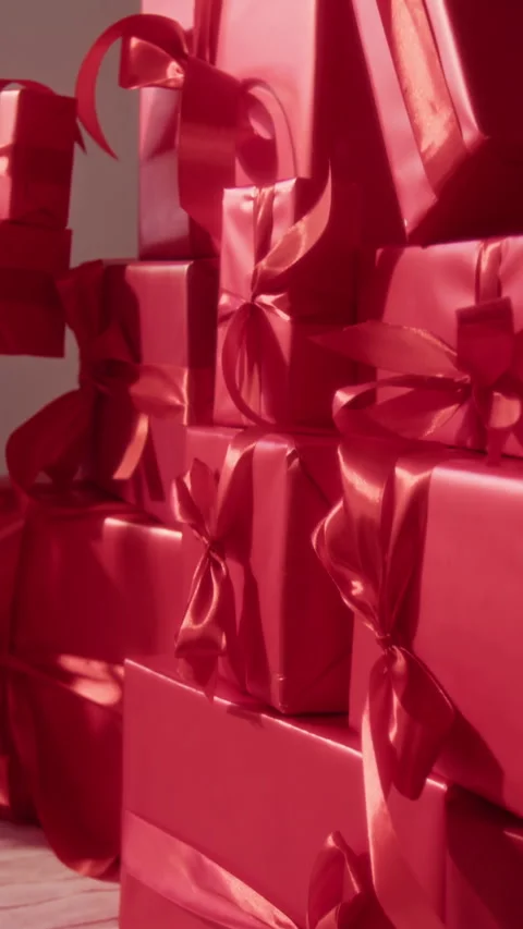 Stacked Group of Gift Boxes Wrapped in Red Paper and Decorated with Ribbons Stock Footage 326606268