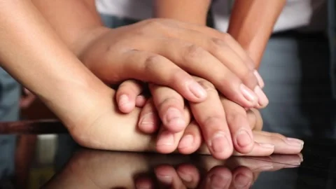Stacked hands symbolizing team effort. Vídeo Stock 346874292