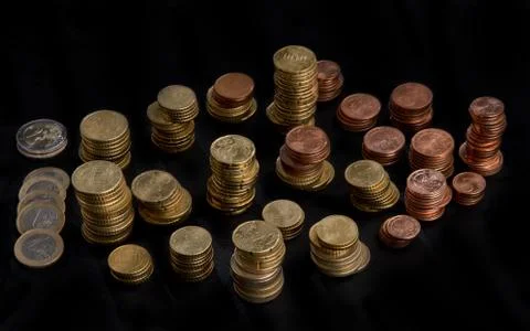Stacked heaps of coins Stock Photos