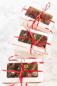 Stacked Holiday Cookie Gift Boxes Wrapped with Red Ribbon 스톡 사진