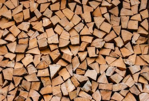 Stacked logs for home heating, background, wallpaper Stock Photos