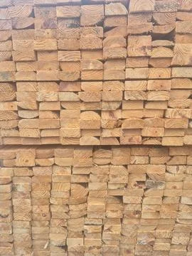 Stacked Lumber Ends Forming a Repeating Wood Grain Pattern Stock Photos