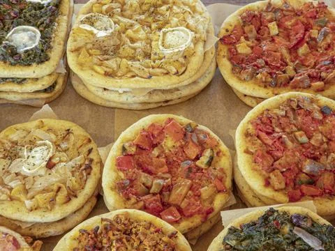 Stacked mini flatbreads topped with roasted peppers, spinach, onions, and g.. Stock Photos