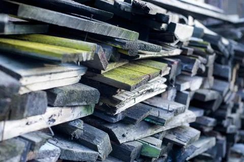 Stacked old boards of disassembled constructions will be used as firewood Stock Photos
