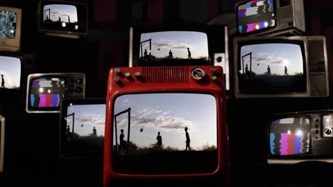 Stacked Old TVs Displaying Kids Playing Rural Soccer at Sunset - 4K Stock Footage 332866168