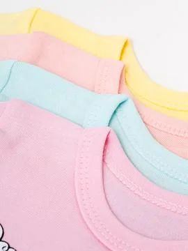 Stacked pastel bodysuits close up view Stock Photos