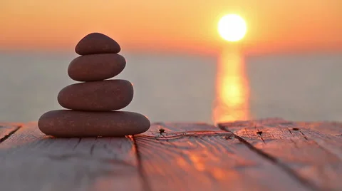 Stacked pebbles and setting sun 스톡 동영상 58496463