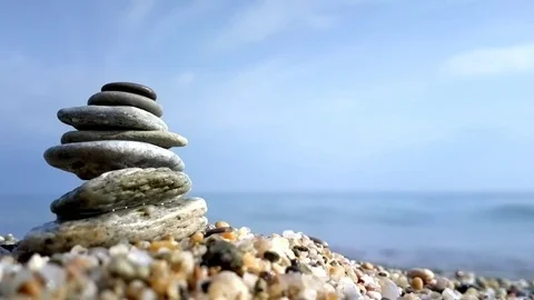 Stacked pebbles on a beach Stock Footage 78897776