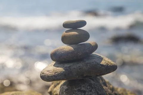 Stacked pebbles on the seashore Stock Photos