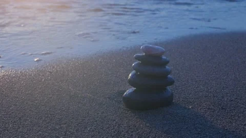Stacked pebbles on the shore. 4K Stock Footage 195645606