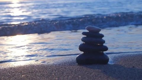Stacked pebbles on the shore. 4K Stock Footage 195654894