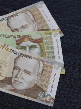 Stacked peruvian banknotes between blue denim fabric Stock Photos