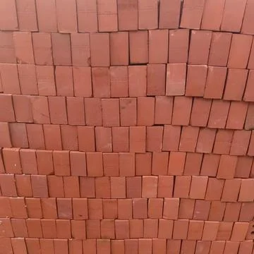 A stacked pile of red clay solid auto bricks Stock Photos