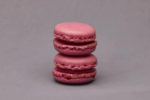 Stacked pink macarons isolated on gray background 스톡 사진