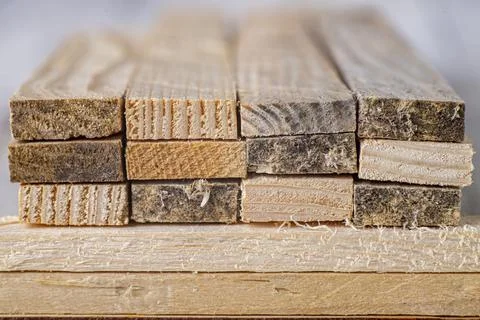 Stacked raw planks. Material for use in a carpentry workshop. Stock Photos