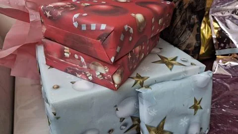 Stacked rectangular holiday gift boxes wrapped in festive decorative paper Stock Photos