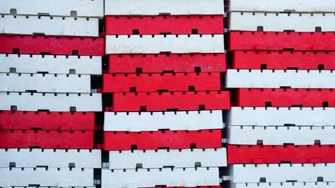 Stacked red and white plastic modular blocks used for docks or barriers Stock Photos
