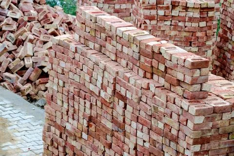 Stacked Red Bricks at Construction Site Stockfoto's