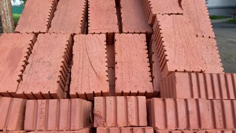 Stacked red ceramic bricks in rows at a construction site Stock Footage 341510511