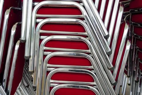 Stacked Red Chairs with Metallic Frames in a Close-Up Arrangement Stock Photos