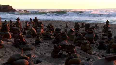 Stacked rocks at the beach at sunset Stock Footage 43240683
