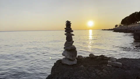 Stacked rocks on the beach at sunset Stock Footage 191606260