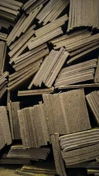 Stacked rough-hewn wooden planks with textured surfaces and layered edges Fotos Stock