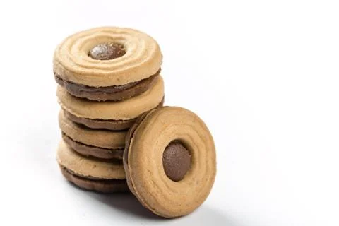 Stacked round biscuits topped with chocolate cream isolated over white backgr Stock Photos