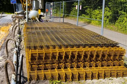 Stacked rust-colored reinforcement mesh on a construction site Stock Photos
