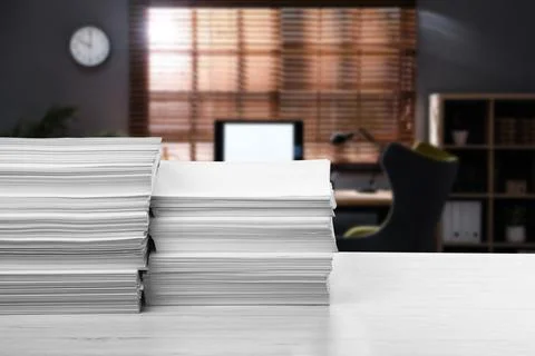 Stacked sheets of paper on white table in office, space for text Stock Photos