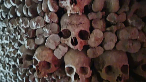 Stacked Skulls and Bone Column in Les Catacombes de Paris Stock Footage 346919593