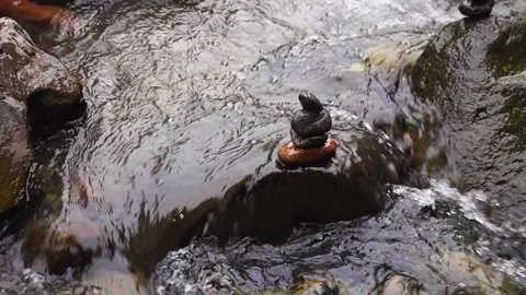 Stacked of small rocks on the top of a boulder Stock Footage 204886138