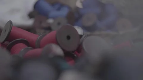 Stacked spools of red and blue thread Stock Footage 248799420