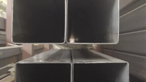 Stacked steel pipe with sunlight reflecting on the interior walls of central Stock Footage