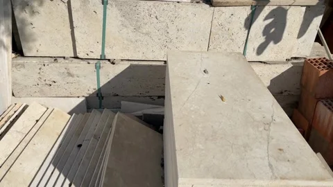 Stacked stone slabs for construction, featuring various textures and colors.. Video stock 328710343