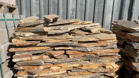 Stacked stone slabs under sunlight, creating rustic textured background sui.. Stock Footage 328968644