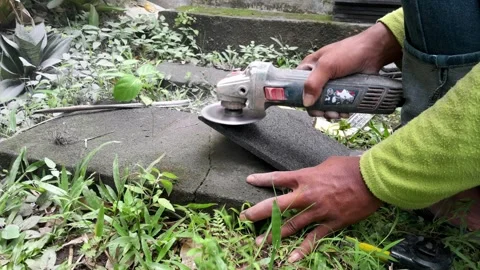 Stacked stone tiles and angle grinder Stock Footage 324324306