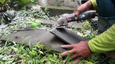 Stacked stone tiles and angle grinder Stock Footage 324324332