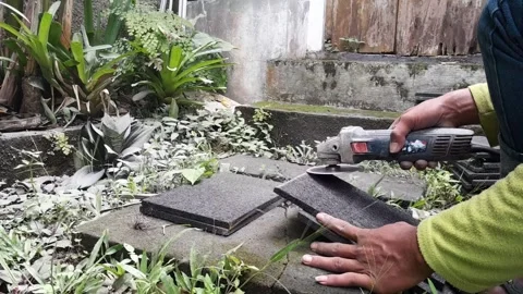 Stacked stone tiles and angle grinder Stock Footage 324324673