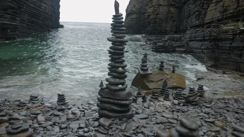 Stacked stone tower at a pebble beach Stock Footage 112036996
