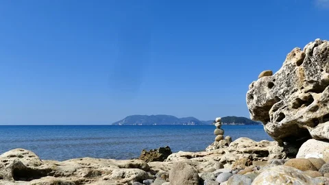 Stacked stones at the beach close up Stock Footage 128758093