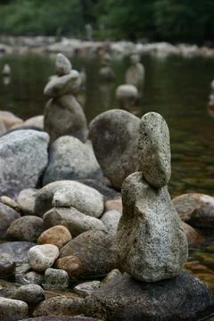 Stacked stones on the river side Stock Photos